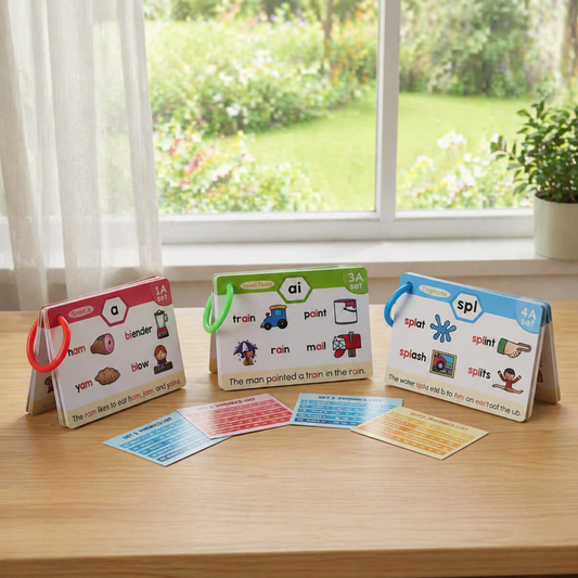 Educational language learning cards on a wooden table with a window in the background.