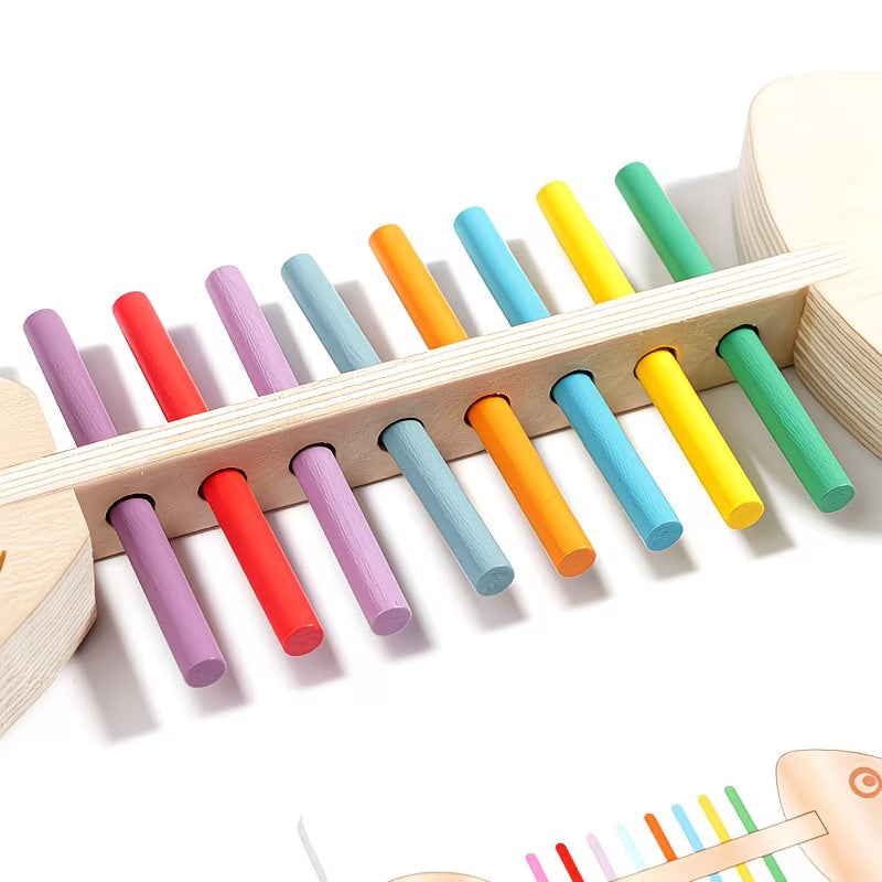 Close-up of a Wooden Fish Bone Puzzle with colorful sorting rods. This educational toy helps develop color recognition, fine motor skills, and cognitive abilities in young children. The toy features vibrant, color-coded sticks placed in a wooden fish-shaped frame, perfect for interactive learning and sensory play. Ideal for early childhood development and Montessori-style education.