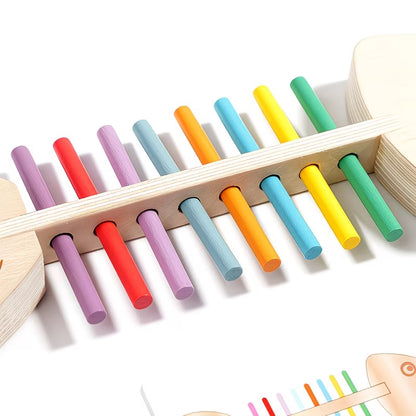Close-up of a Wooden Fish Bone Puzzle with colorful sorting rods. This educational toy helps develop color recognition, fine motor skills, and cognitive abilities in young children. The toy features vibrant, color-coded sticks placed in a wooden fish-shaped frame, perfect for interactive learning and sensory play. Ideal for early childhood development and Montessori-style education.